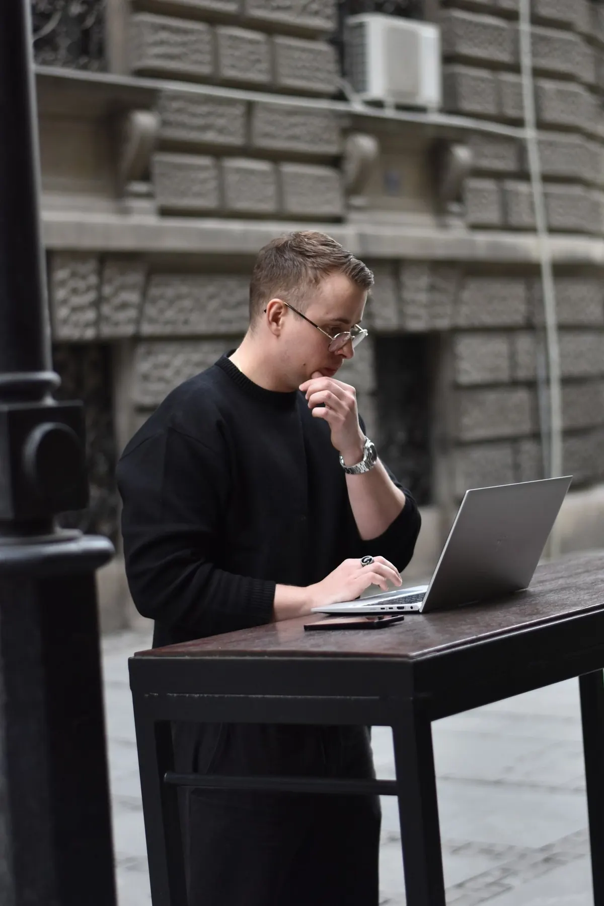 Christopher Krassnig working on a laptop outdoors